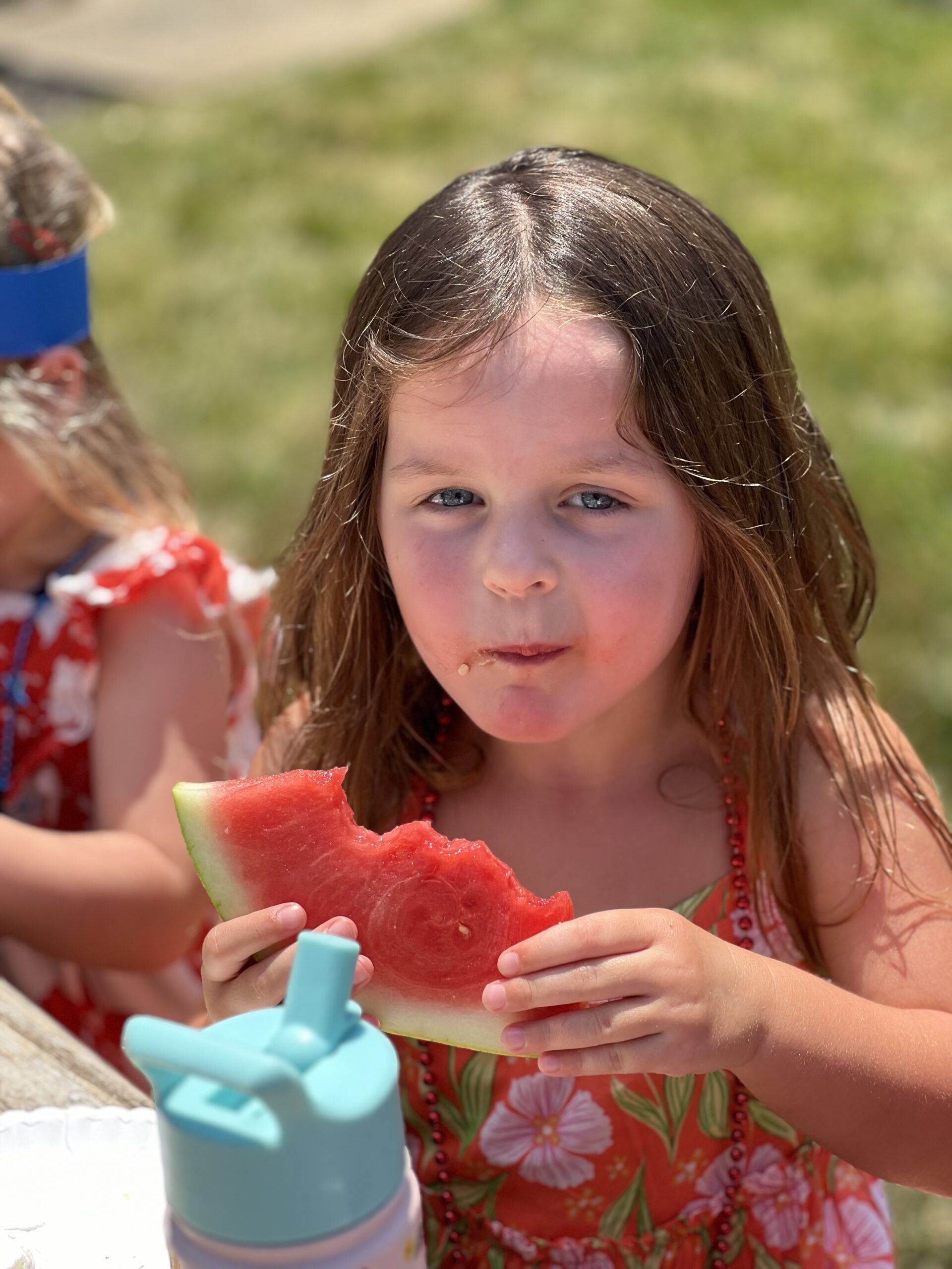 Norbeck Montessori Child enjoying fruit at summer camp image